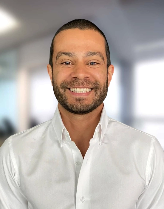 Chiropractor Kevin Tomassini Smiling In Front Of Blurred Background