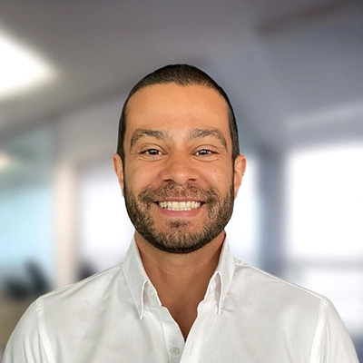 Chiropractor Kevin Tomassini Smiling In Front Of Blurred Background