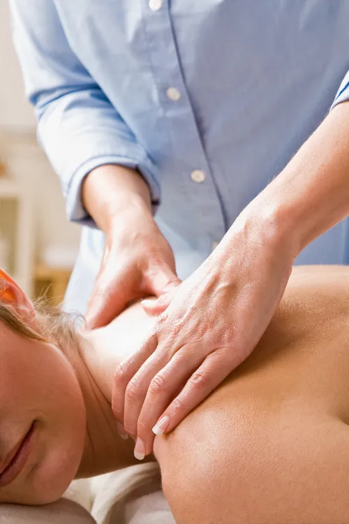 Woman Receiving Massage Therapy On Shoulders